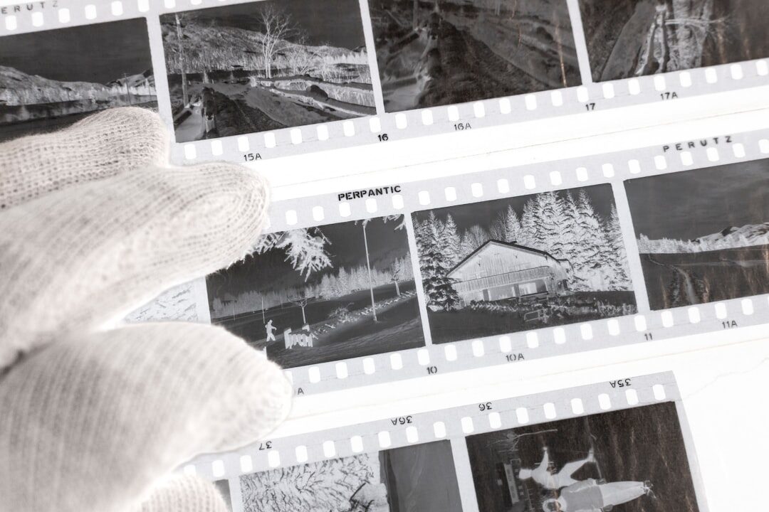 Close-up of a hand developing black and white film photographs