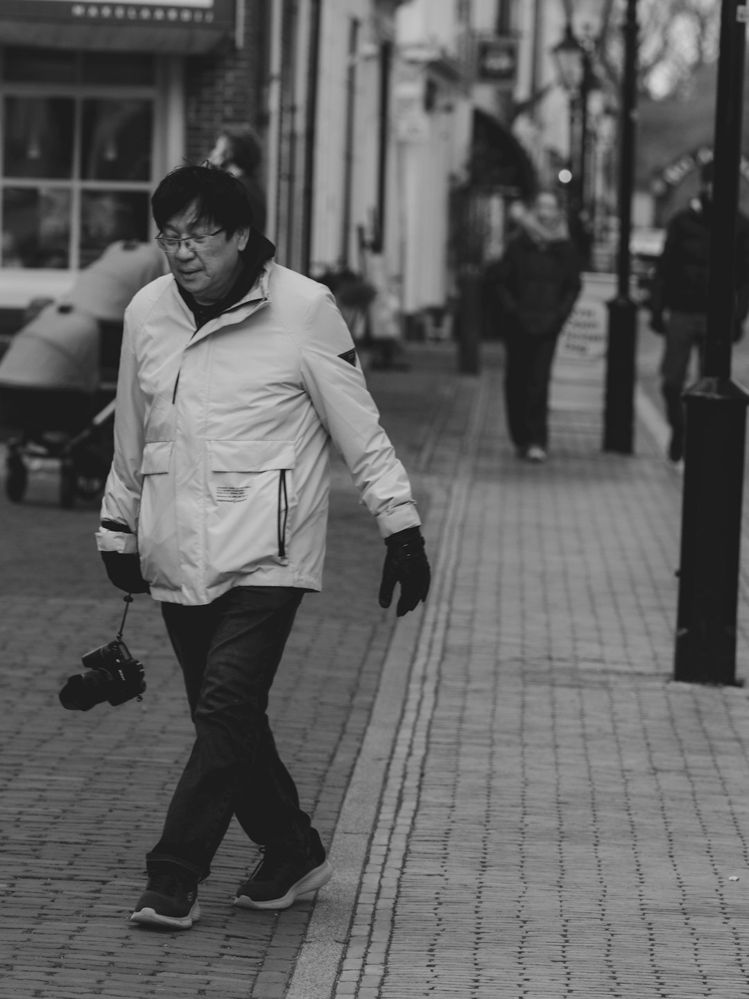 Danish woman documentary photographer holding a camera in an urban street