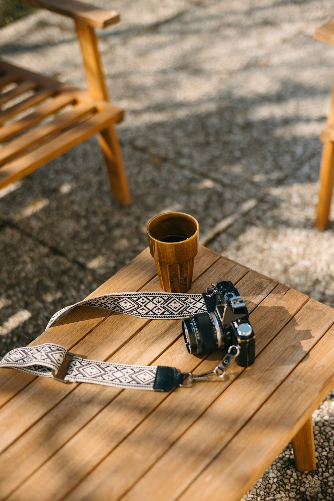 Rolls of exposed film and a vintage camera on a wooden table